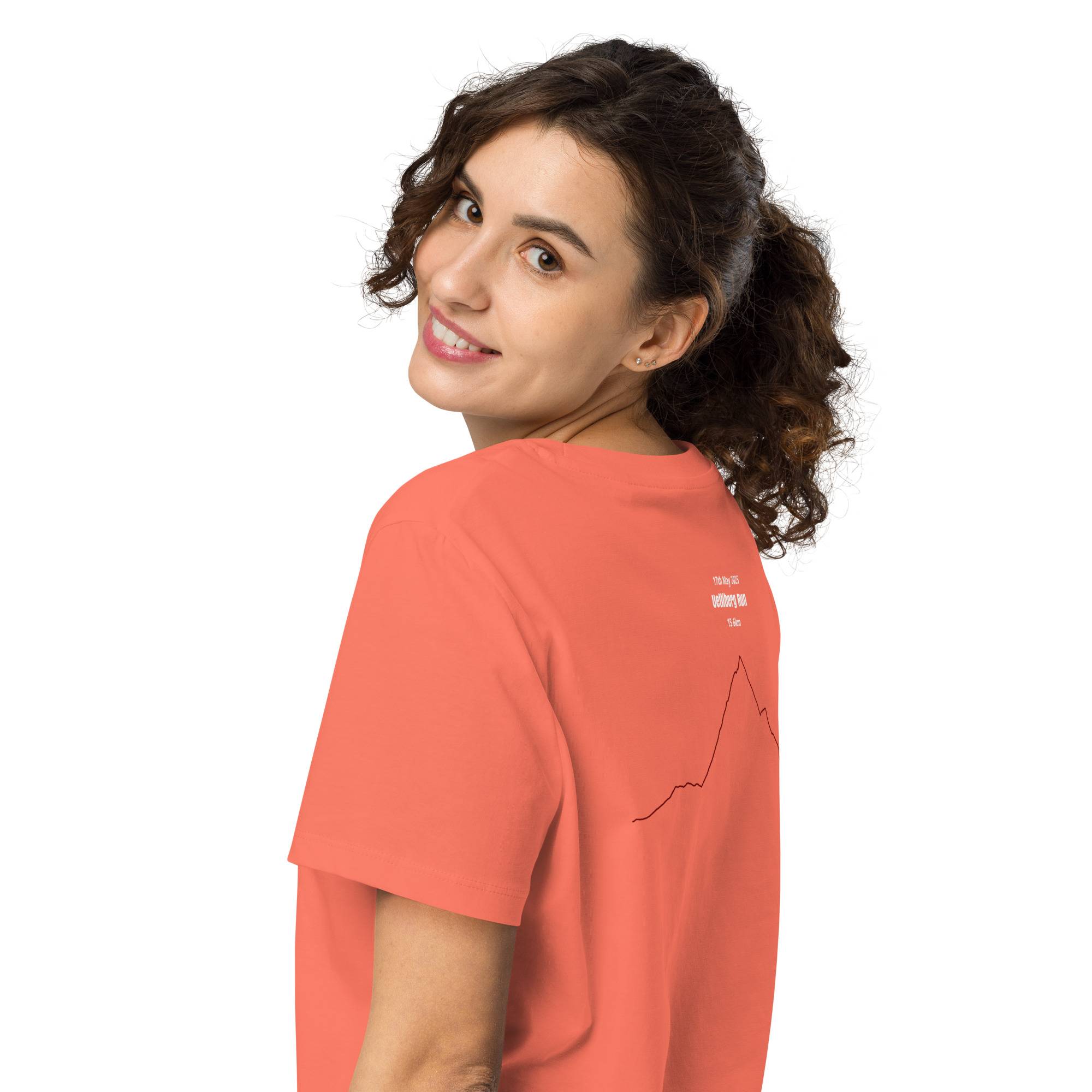 Woman wearing an orange t-shirt with a custom Strava route print on a white background
