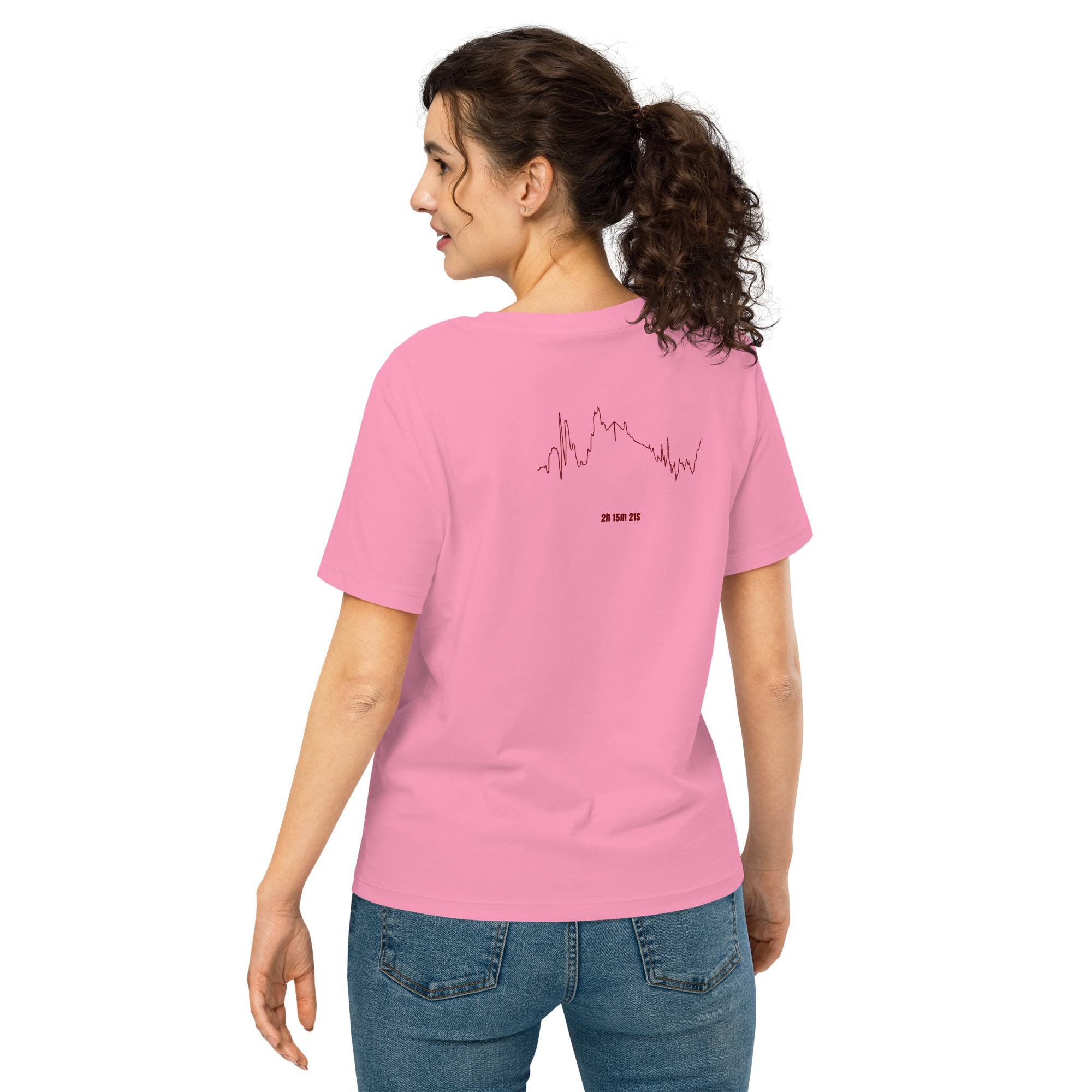Woman wearing a pink t-shirt with a custom Strava route print design on the back, standing against a white background