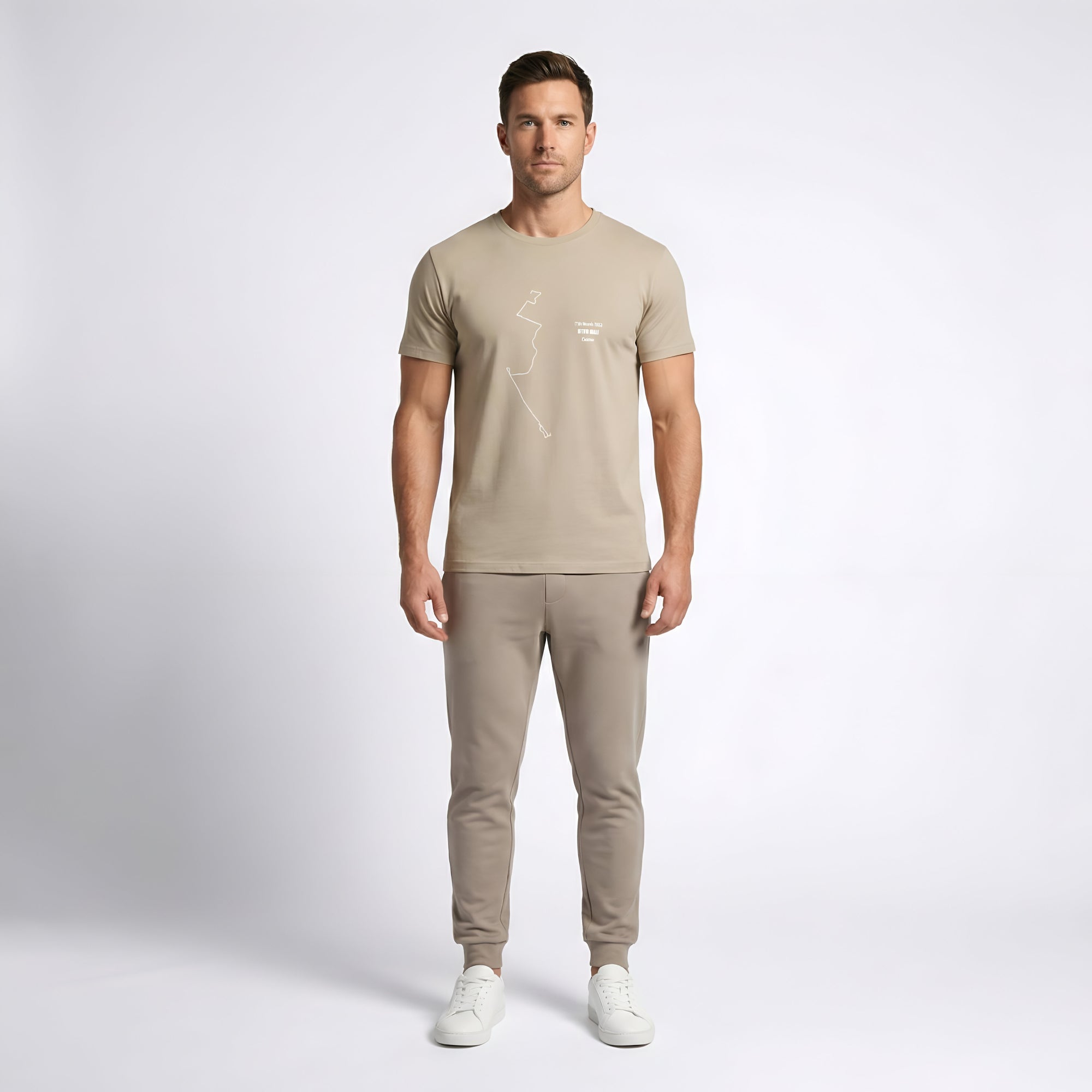 Man wearing a brown t-shirt with custom Strava route print art and trousers on a white background