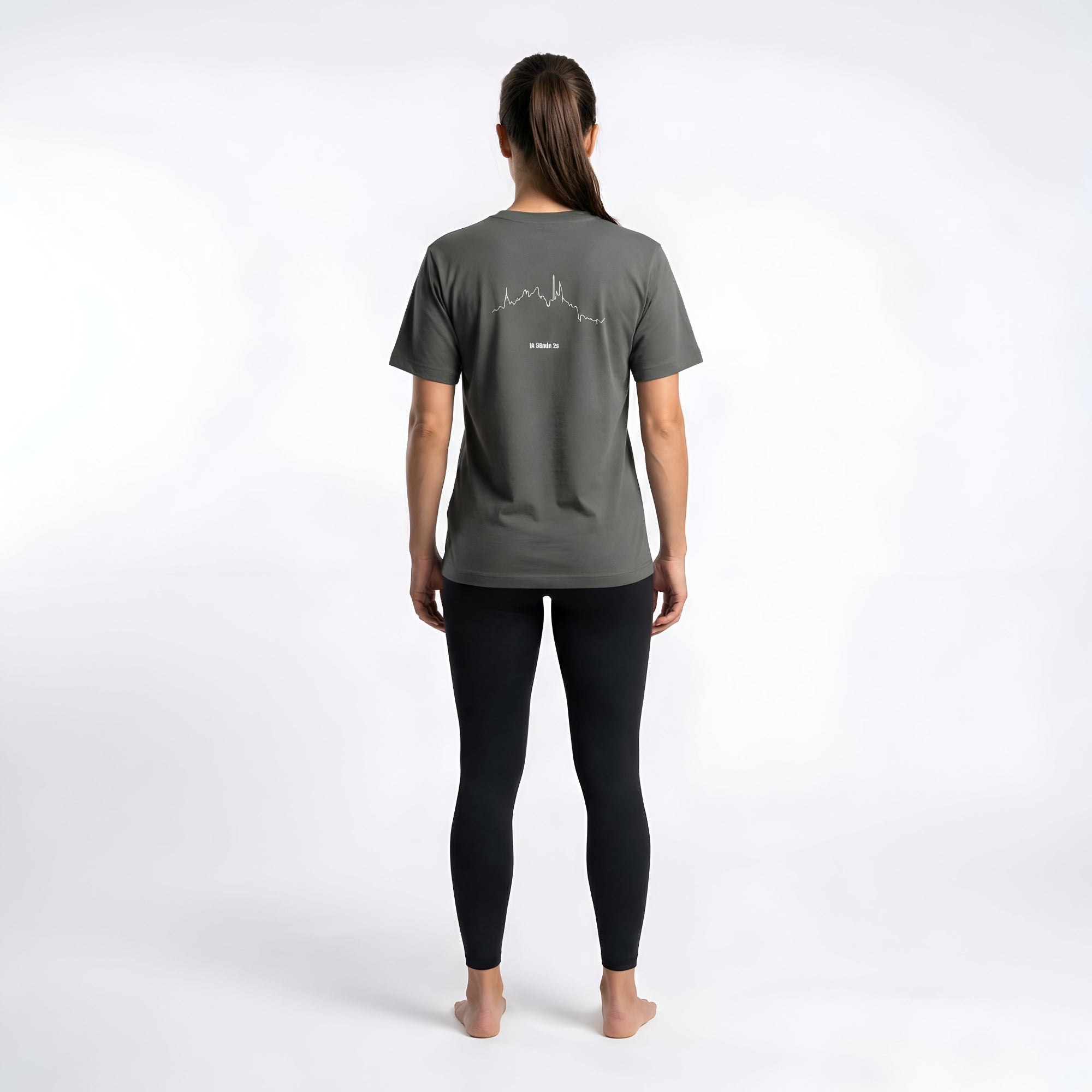 Woman wearing a dark gray t-shirt with a white custom Strava route print art design on the back against a white background