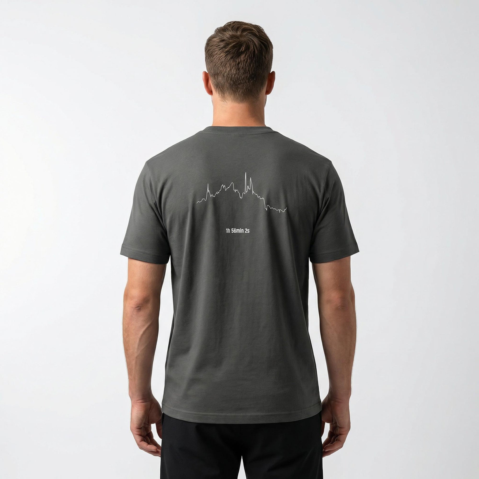 Man wearing a dark gray t-shirt with a white custom Strava route print art design on the back against a white background