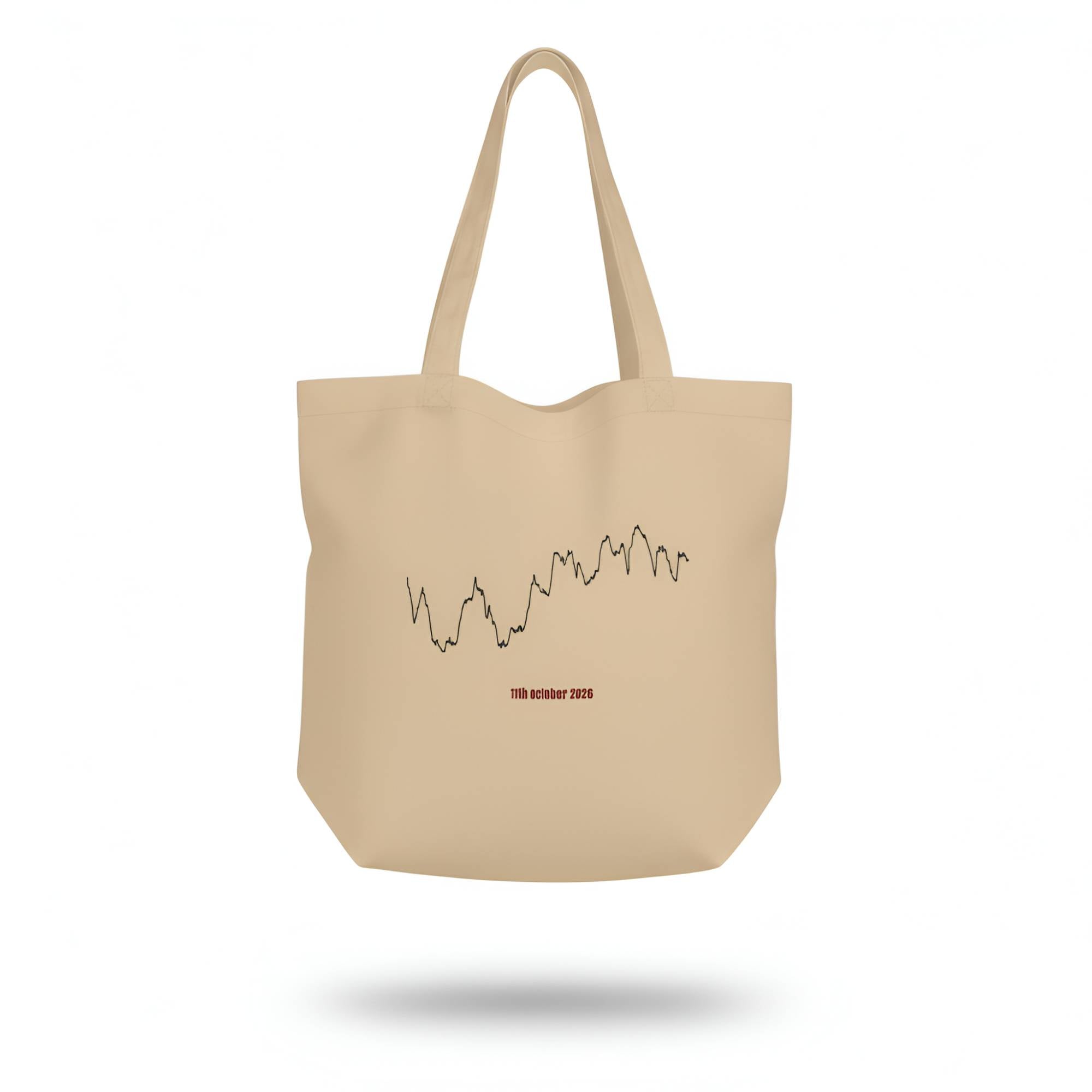 Beige tote bag with a printed custom Strava route art design on a white background