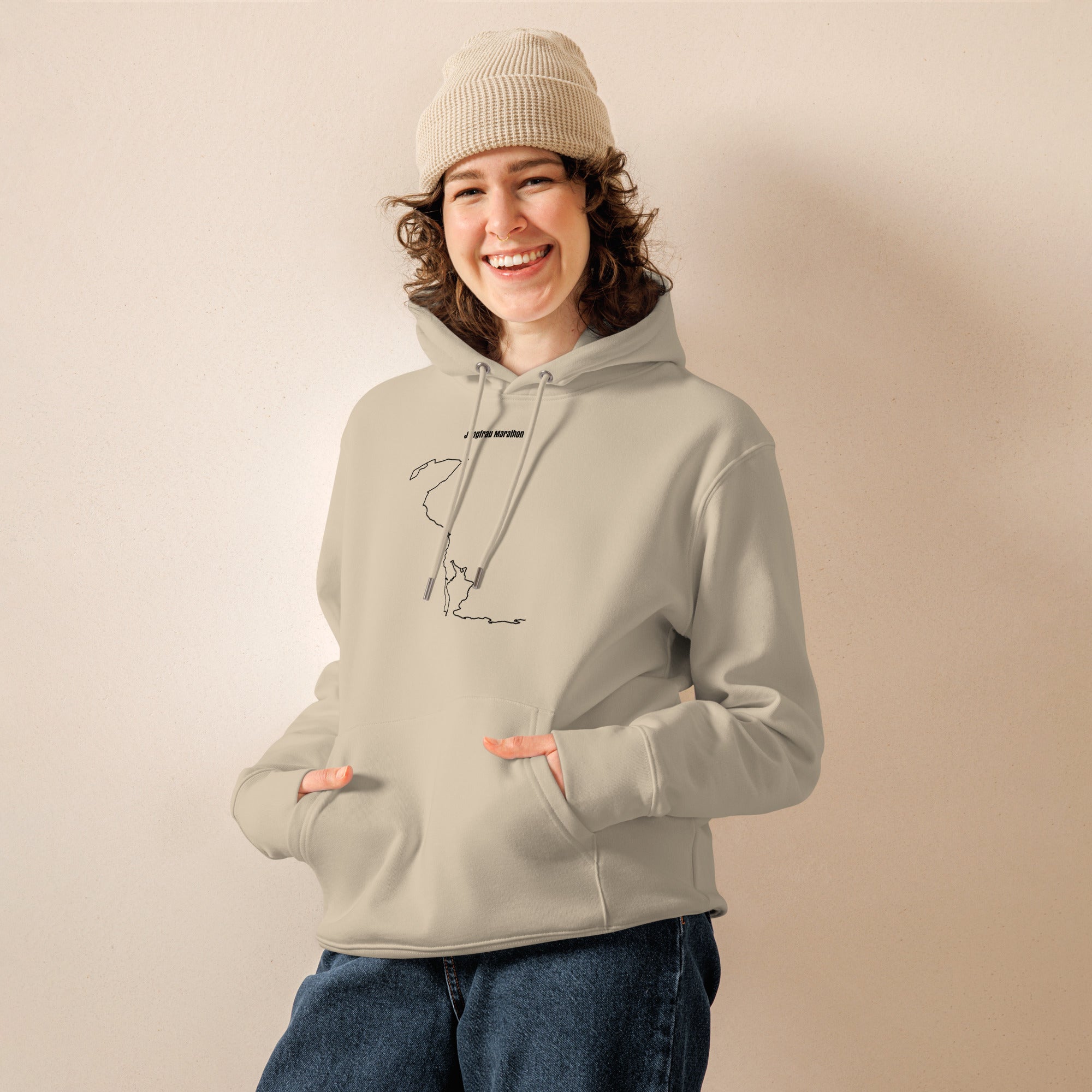 Person wearing a light gray hoodie with a custom Strava route print art on a beige background