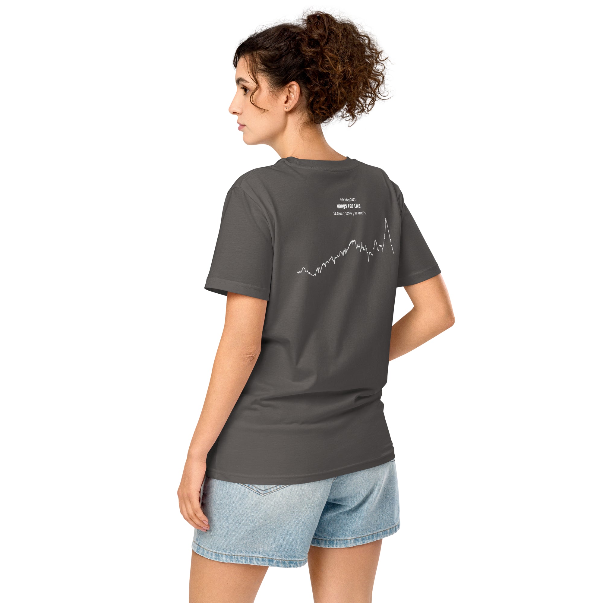 Woman wearing a gray t-shirt with a custom Strava route print art design on the back, standing against a white background