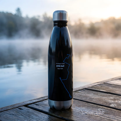 Black water bottle with a custom Strava print art design on a wooden dock by a lake