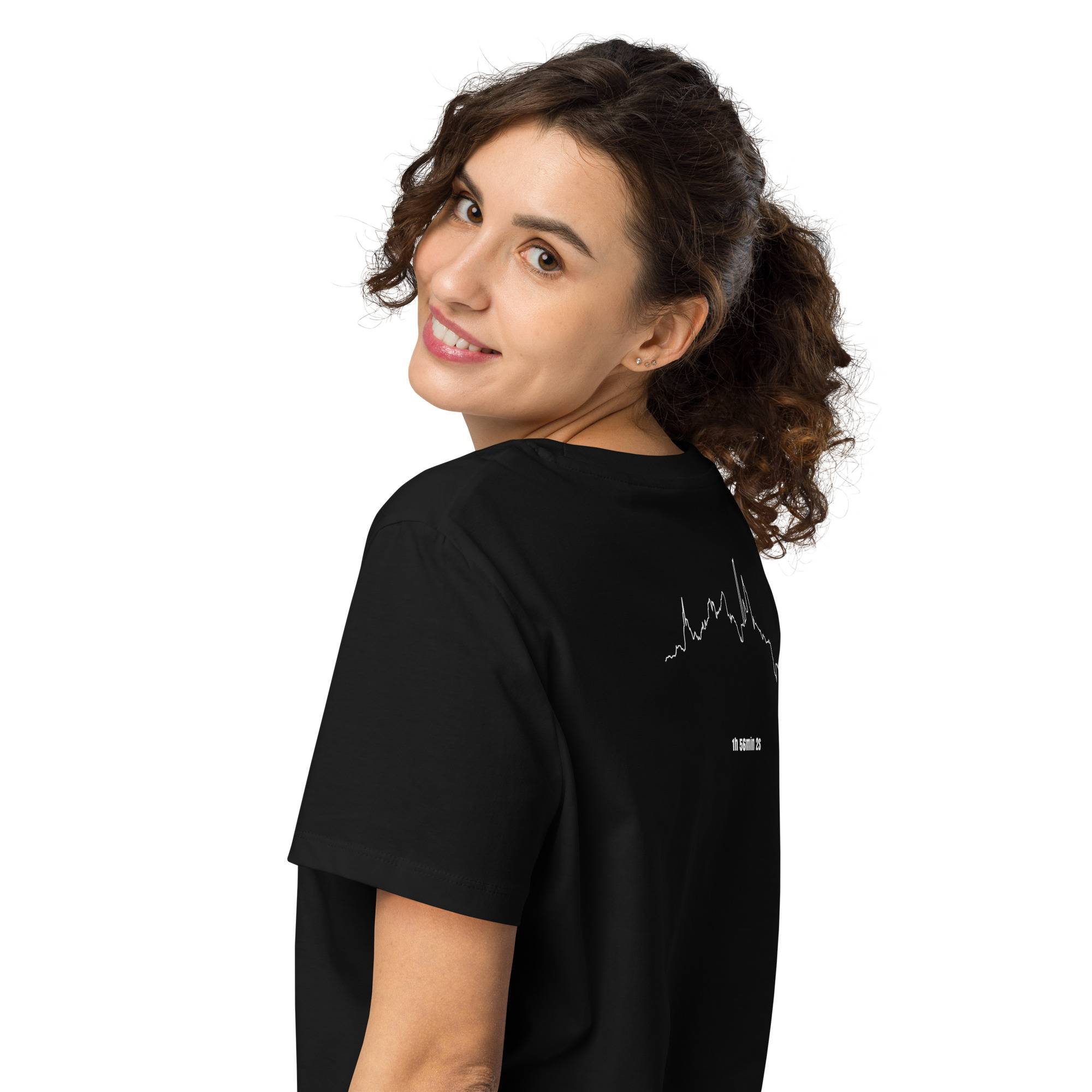 Woman wearing a black t-shirt with a custom Strava route print on the back against a white background