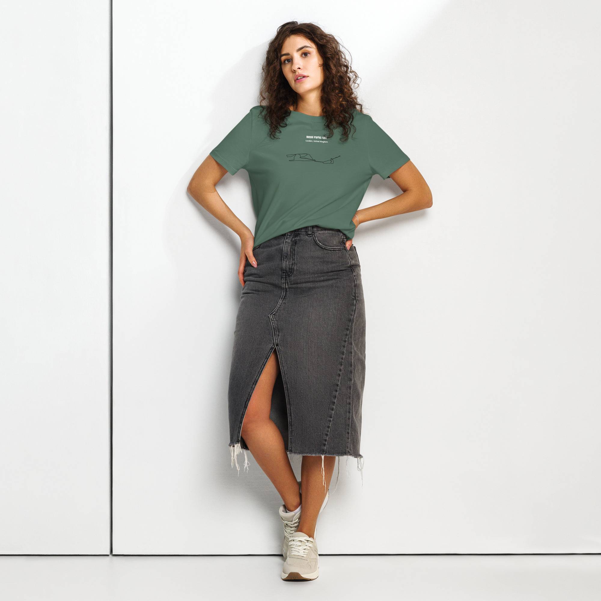Woman wearing a green t-shirt with custom Strava route print and black denim skirt on a white background