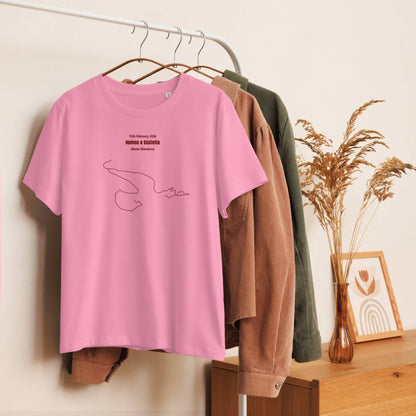 Pink t-shirt with a custom Strava route print design on a hanger against a neutral wall with clothes and decor