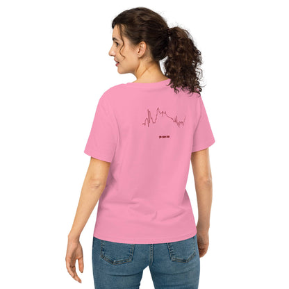 Woman wearing a pink t-shirt with a custom Strava route print design on the back, standing against a white background