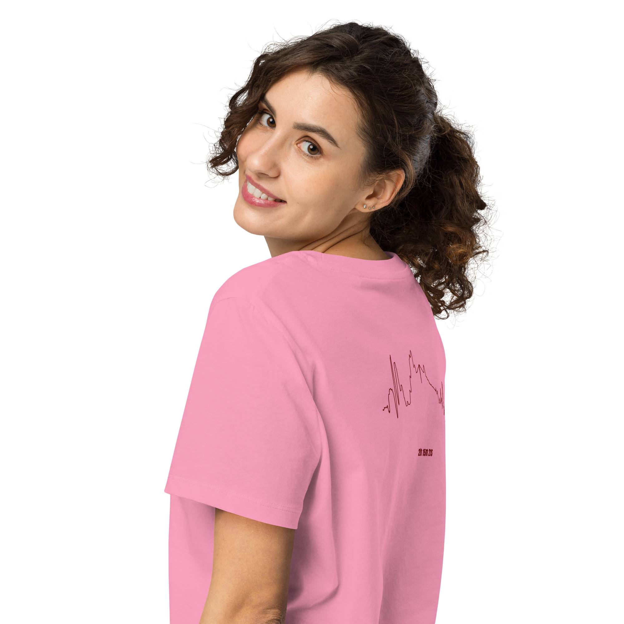 Woman wearing a pink t-shirt with text and custom Strava route print on the back against a white background