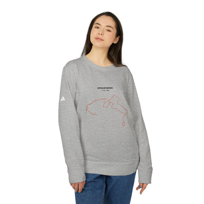 Person wearing a gray sweatshirt with a custom Strava route print art on a white background