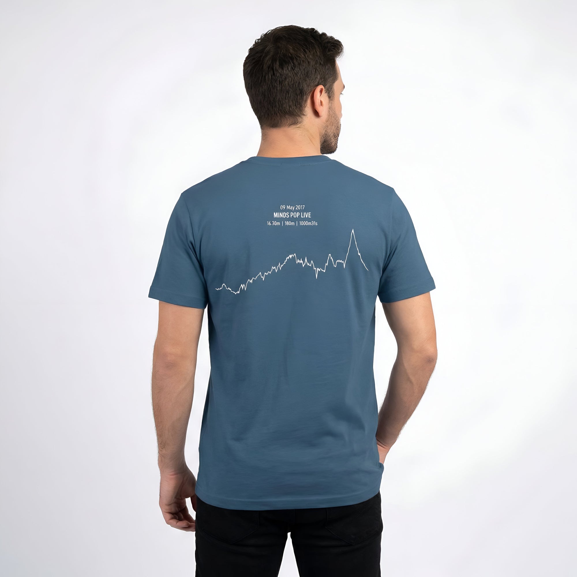 Man wearing a blue t-shirt with a white custom Strava route print art design on the back against a white background