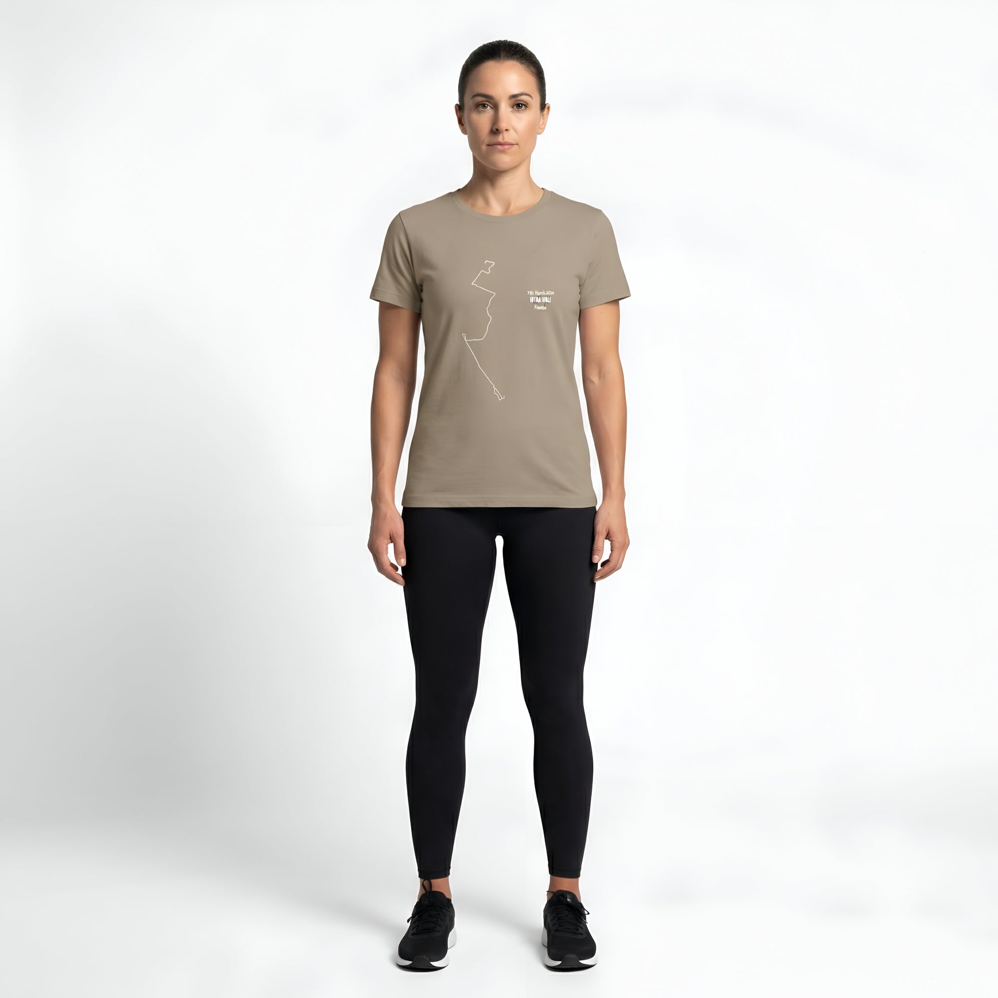 Woman wearing a beige t-shirt with custom Strava route print art and black leggings on a white background
