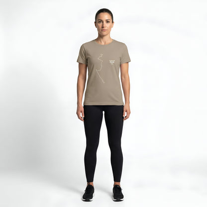 Woman wearing a beige t-shirt with custom Strava route print art and black leggings on a white background