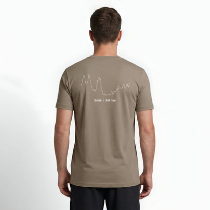 Person wearing a brown t-shirt with custom Strava route print art design on the back against a white background