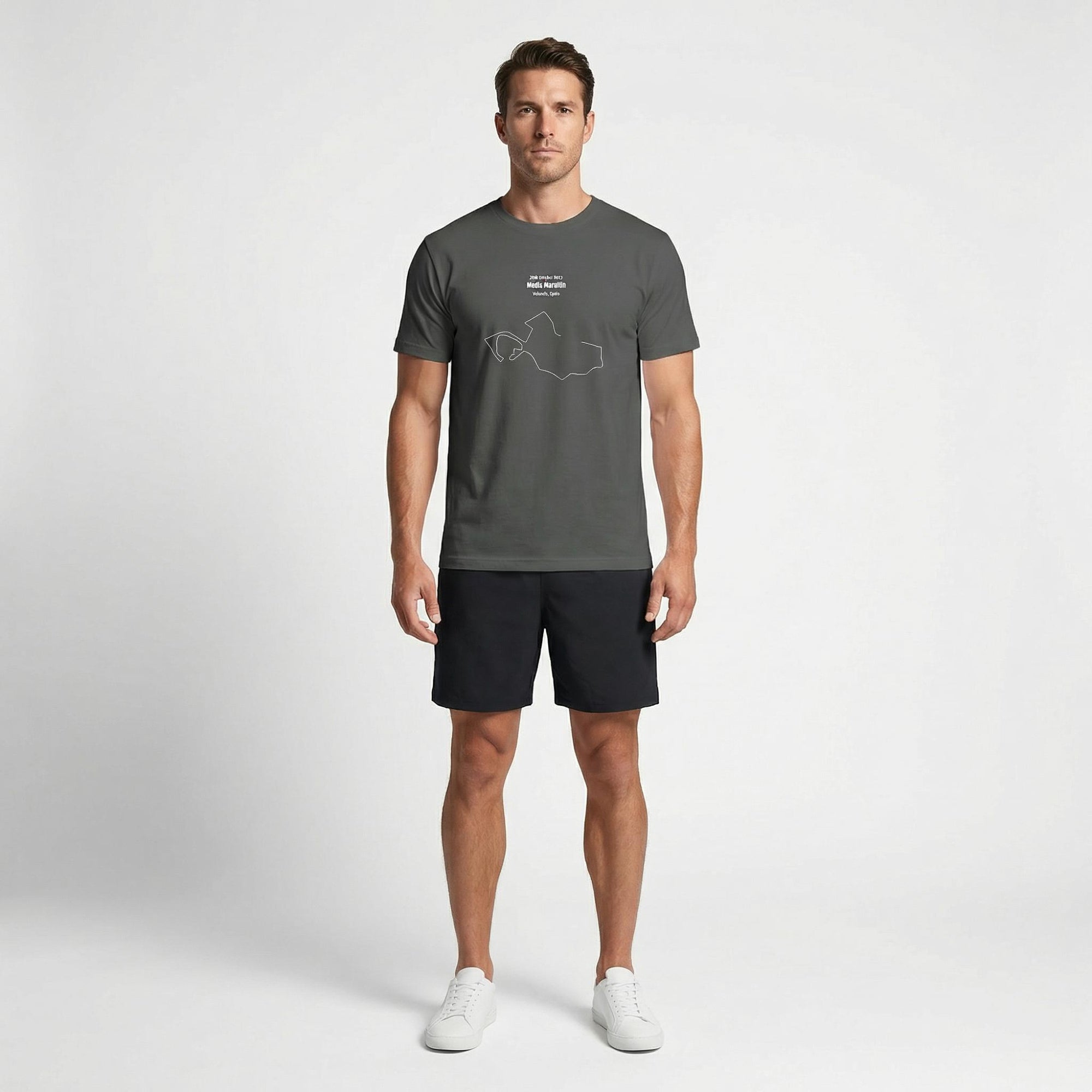 Man wearing a gray t-shirt with custom Strava route print art design and black shorts on a white background