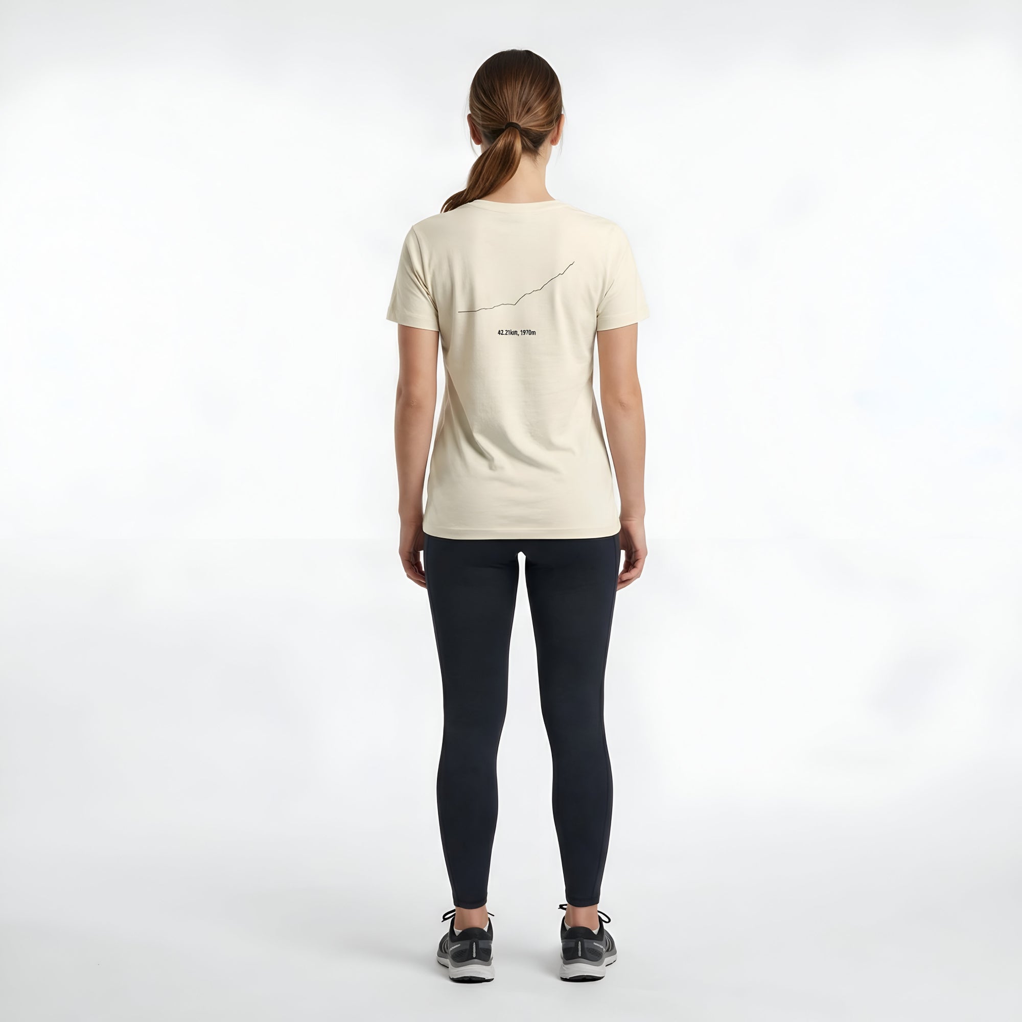 Woman wearing a beige t-shirt with custom Strava route print art design on the back against a white background