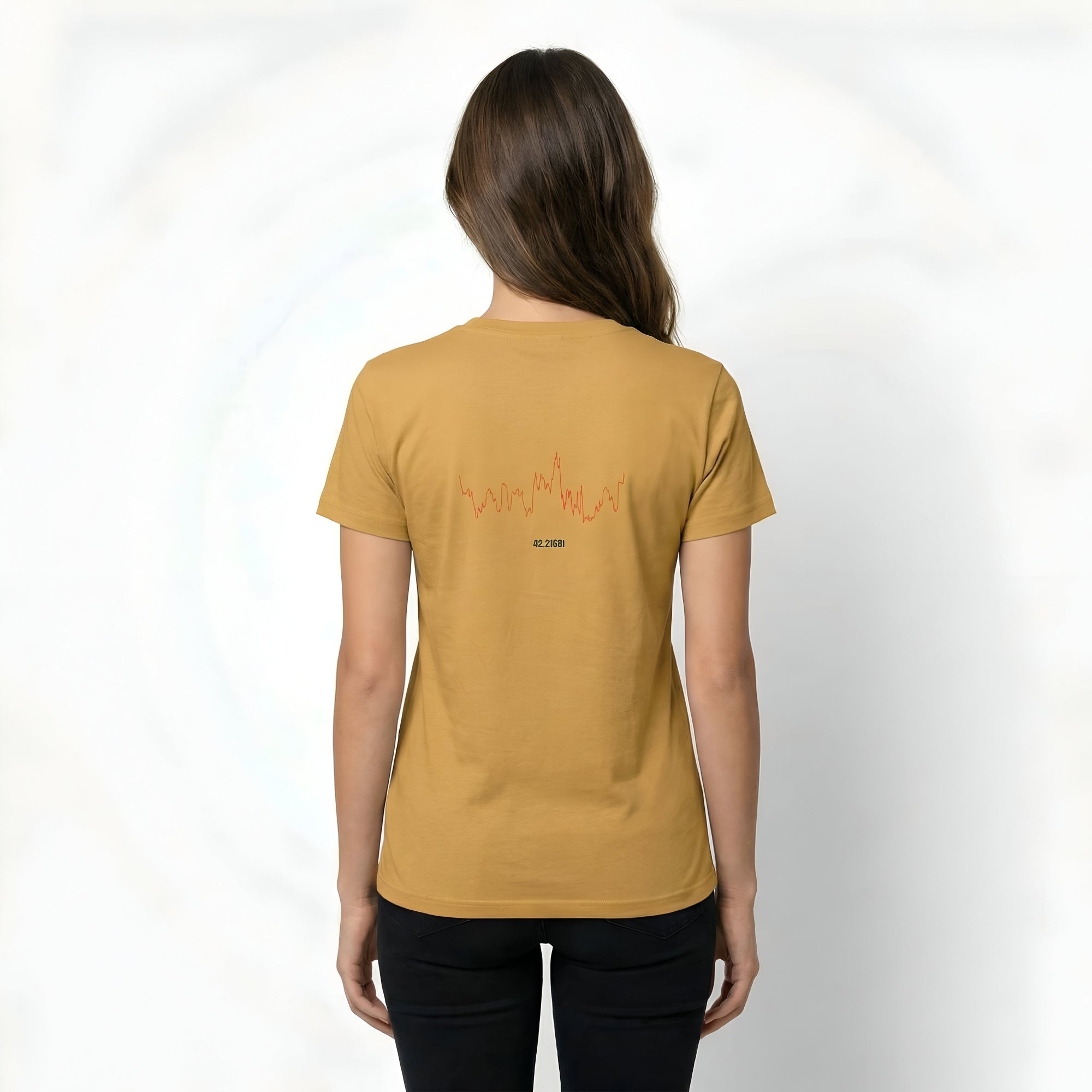 Person wearing a mustard yellow t-shirt with text on the back and custom Strava route print art design against a white background