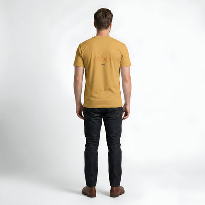 Person wearing a mustard yellow t-shirt with custom Strava route print art design on the back against a white background