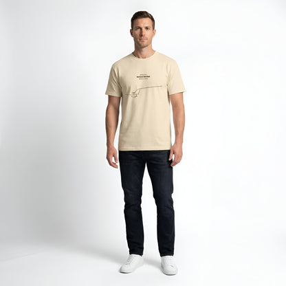 Man wearing a beige t-shirt with custom Strava route print art design and dark jeans on a white background