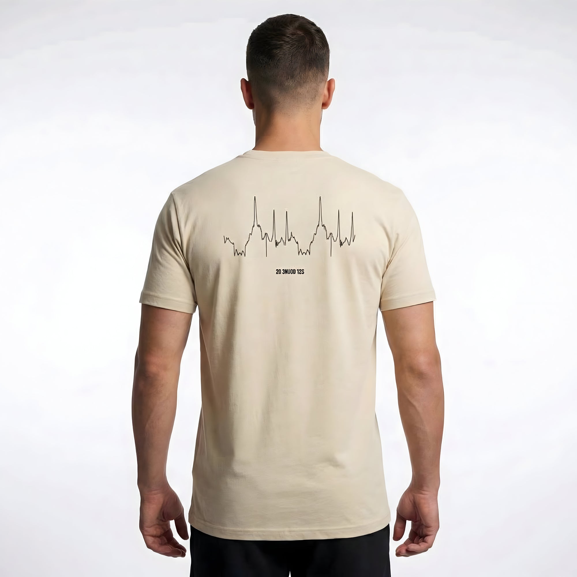 Man wearing a beige t-shirt with a custom Strava route print art design on the back against a white background