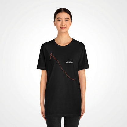 Person wearing a black t-shirt with a custom Strava route print art design on a white background