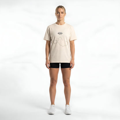 Person wearing a beige t-shirt with a custom Strava route print art design on a white background