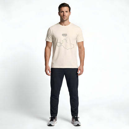 Man wearing a beige t-shirt with custom Strava route print art design on a white background