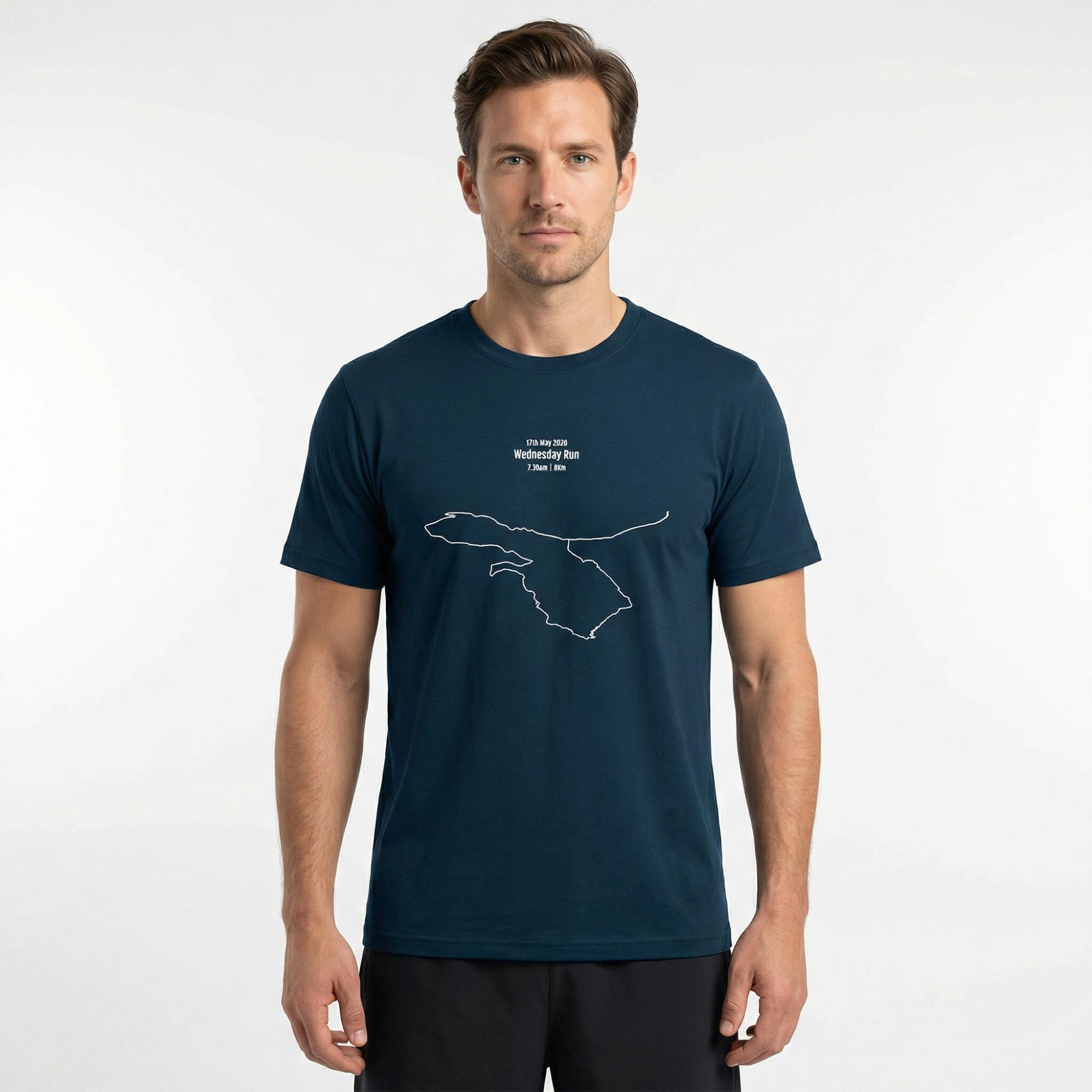 Man wearing a navy blue t-shirt with a custom Strava route print art design on a white background