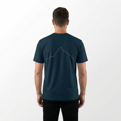 Man wearing a teal t-shirt with a custom Strava route print art design on the back against a white background
