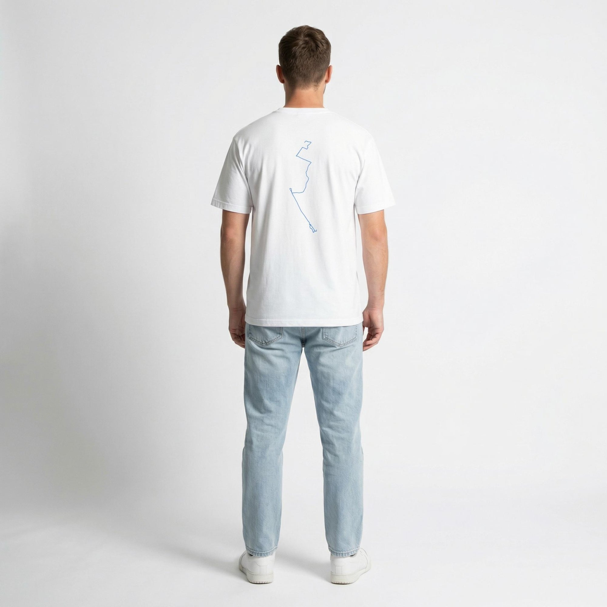 Man wearing a white t-shirt with a blue custom Strava route print art design and light blue jeans on a white background