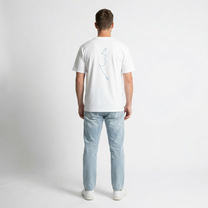 Man wearing a white t-shirt with a blue custom Strava route print art design and light blue jeans on a white background