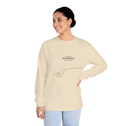 Woman wearing a beige long-sleeve shirt with custom Strava route print art design on a white background