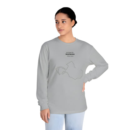 Woman wearing a gray long-sleeve shirt with a custom Strava route print art design and text on a white background