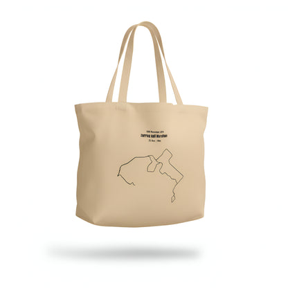 Beige tote bag with a black custom Strava route print art on a white background