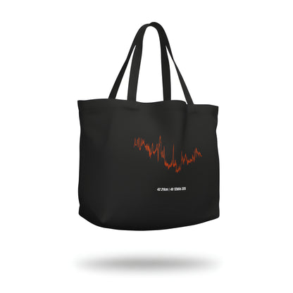 Black tote bag with red and white custom Strava route print art design on a white background