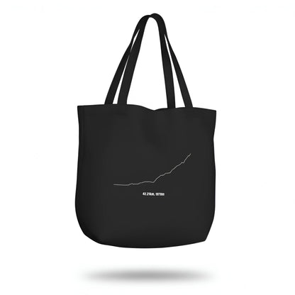 Black tote bag with a white custom Strava route print art design on a white background
