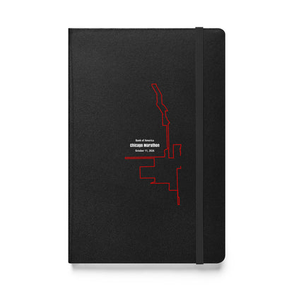 Black notebook with red custom Strava route print art design on a white background