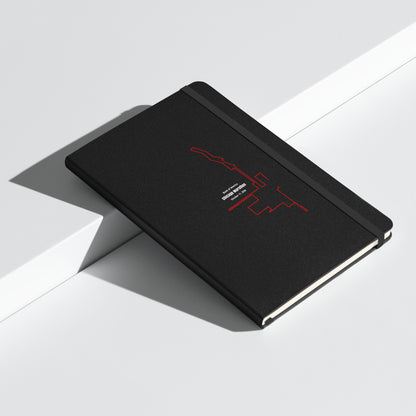 Black notebook with red custom Strava route print art design on a white surface
