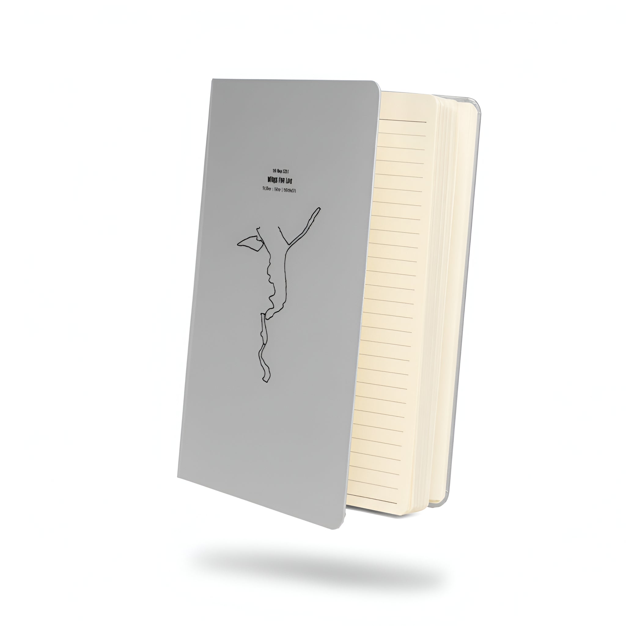 Notebook with gray cover with custom Strava route print art and white pages on a white background