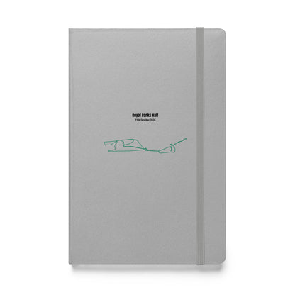 Gray notebook with a green custom Strava route print art design on a white background