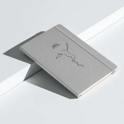 Gray notebook with custom Strava route print art design on a light gray background