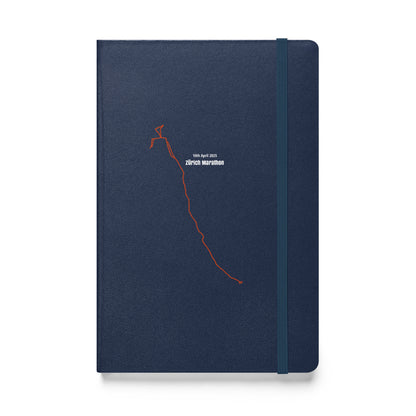 Navy blue notebook with red custom Strava route print art on a white background