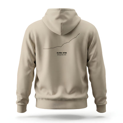 Beige hoodie with a custom Strava route print art design on the back against a white background