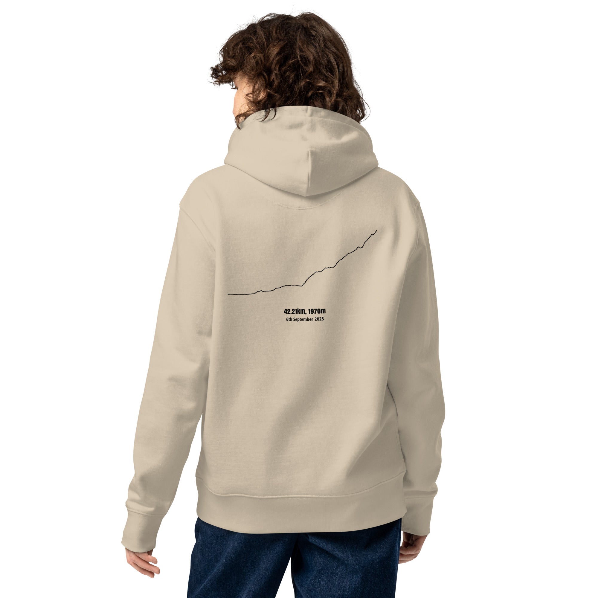 Person wearing a beige hoodie with a custom Strava route print art design on the back against a white background