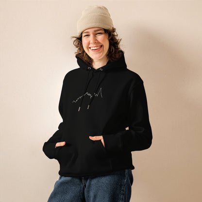 Person wearing a black hoodie with custom Strava route print art on a beige background