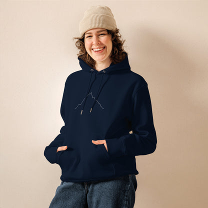 Person wearing a navy hoodie with custom Strava route print art and beige beanie against a beige background
