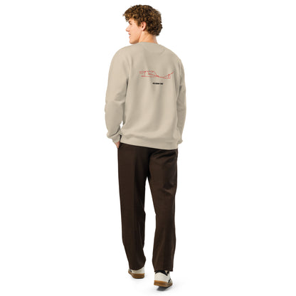 Person wearing a beige sweatshirt with custom Strava route print art on the back, standing against a white background