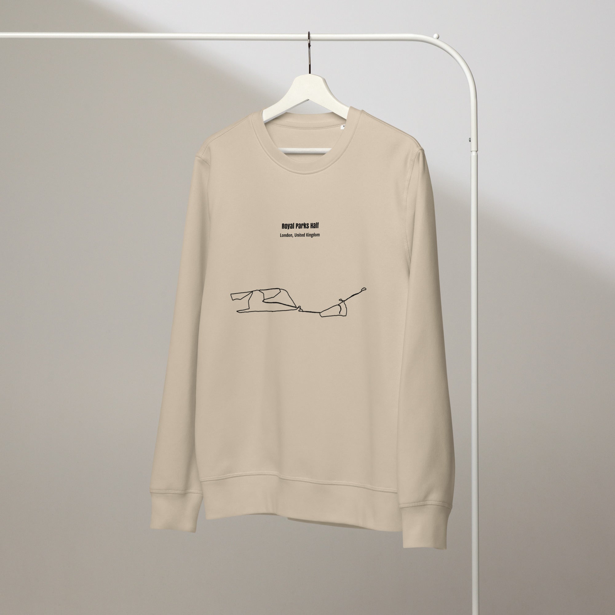 Beige sweatshirt with custom Strava route print art design on a hanger against a plain background