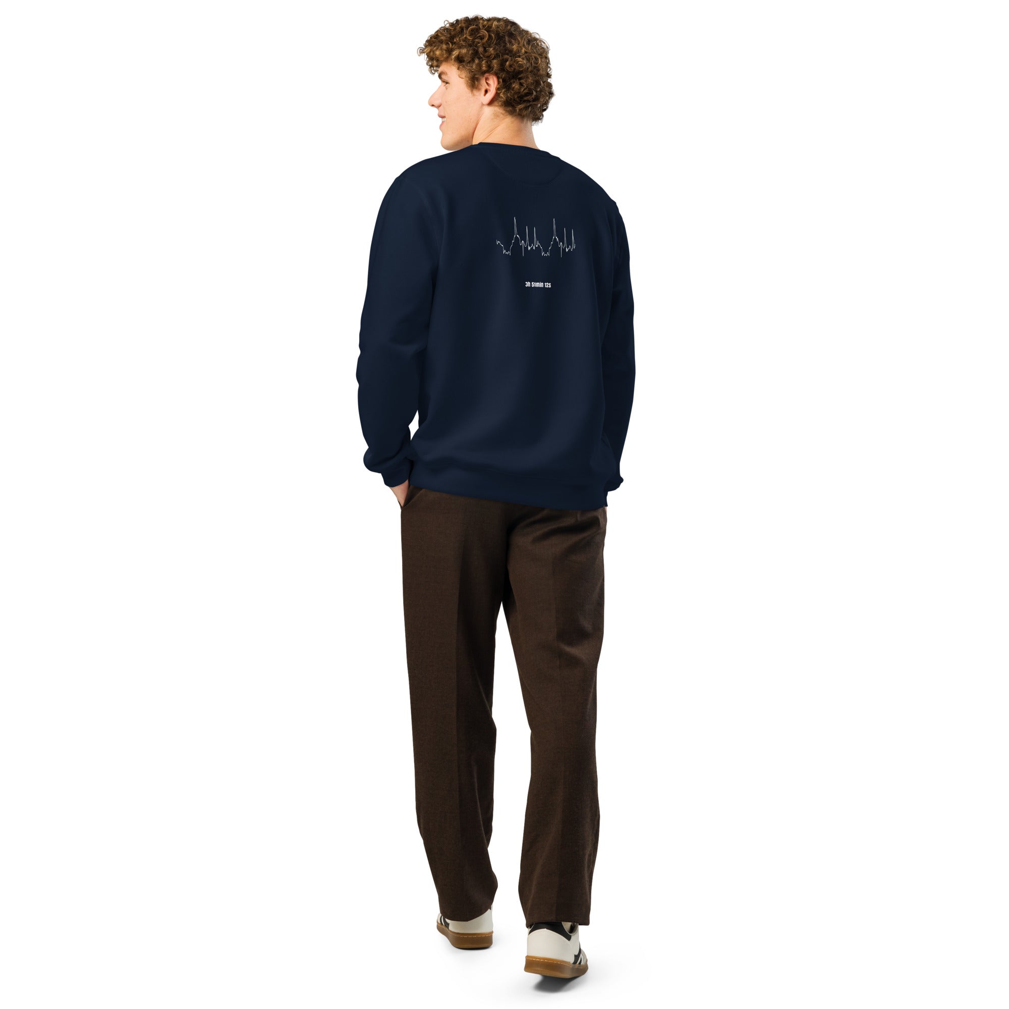 Person wearing a navy sweatshirt with custom Strava route print art on the back, standing against a white background